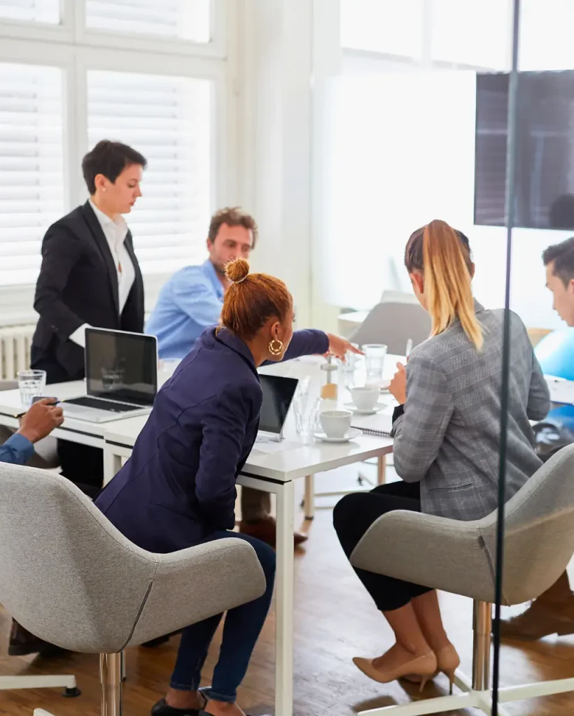 sponsors sitting around table in meeting room
