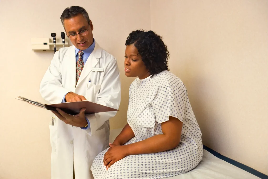 Physician showing chart to patient